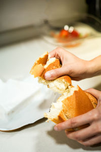 Cropped hand of woman holding food