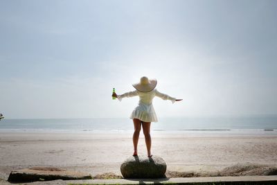 Full length rear view of man standing on beach