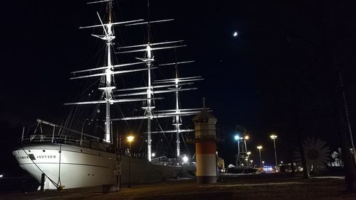 Illuminated lights against sky at night