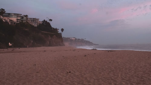 Scenic view of beach against sky during sunset