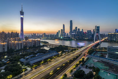 High angle view of illuminated city buildings against sky