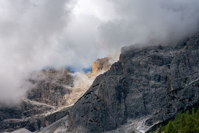 Smoke emitting from mountain against sky