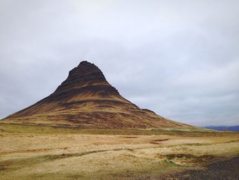 Scenic view of mountains against cloudy sky