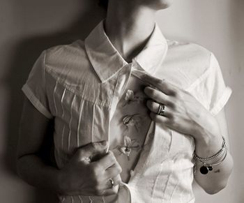 Midsection of woman showing flowers on chest