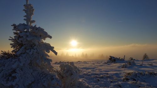 Scenic view of snow against sky during sunset