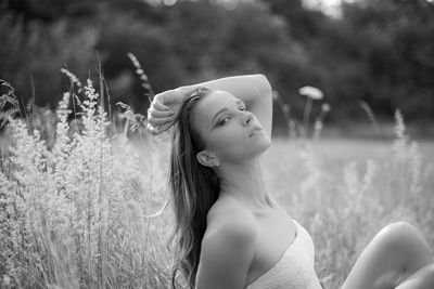 Side view of woman looking away on field