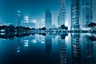 Reflection of illuminated buildings in city