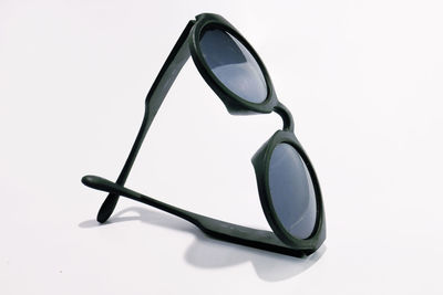 Close-up of sunglasses against white background