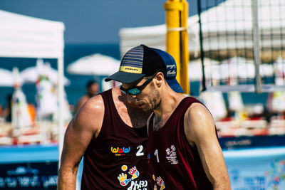 Portrait of young man standing in swimming pool