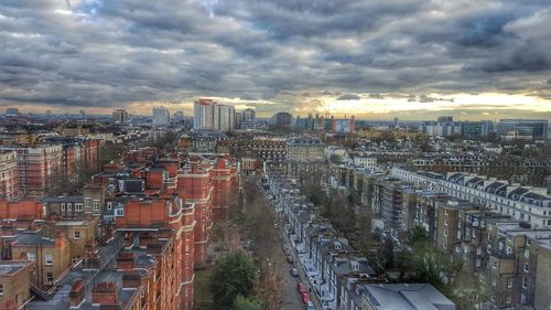 Cityscape against cloudy sky