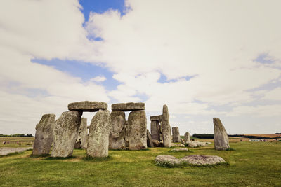 Old ruins on field against sky