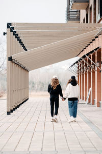 Rear view of girls walking on street