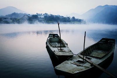 Boats on lake in fog