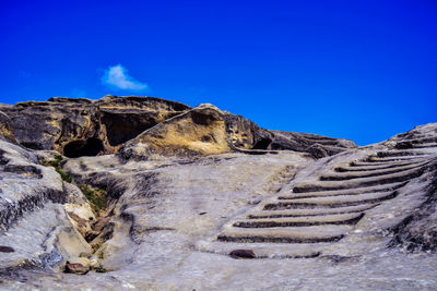 Rock formations against blue sky