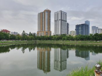 Reflection of buildings in lake against sky