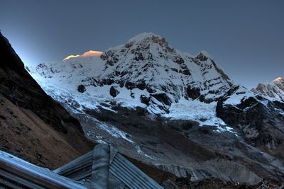 Scenic view of snowcapped mountains against clear sky