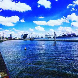 View of harbor against cloudy sky