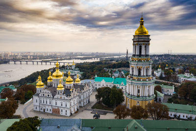 Buildings in city against cloudy sky