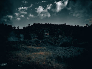 Scenic view of land against sky at dusk