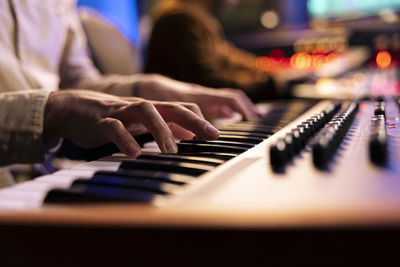 Midsection of woman playing piano