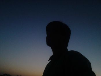Low angle view of silhouette man against clear sky