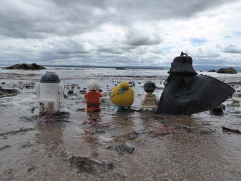 Rocks on beach against sky