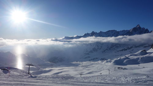 Scenic view of snow covered mountains against clear sky