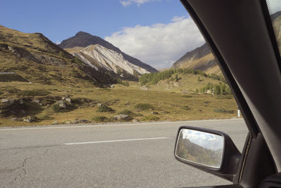 Scenic view of mountains seen through car windshield