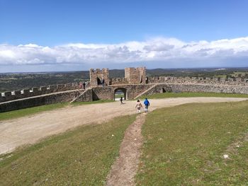 People at observation point against sky