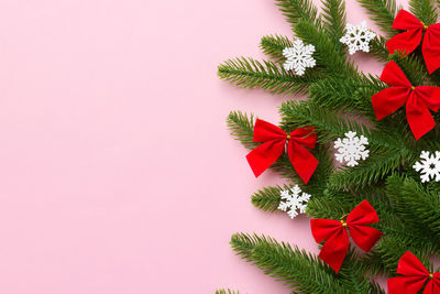 Directly above shot of christmas decorations on pink background