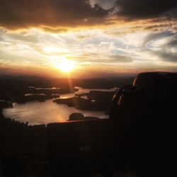 Silhouette of sea against sky during sunset