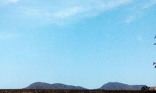 Scenic view of mountains against clear blue sky