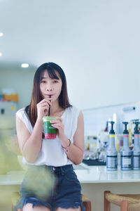 Young woman drinking glass