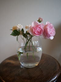 Close-up of rose in glass vase on table