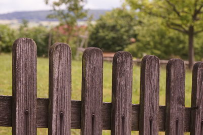 Close-up of wooden fence on field