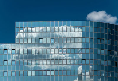 Low angle view of building against cloudy sky