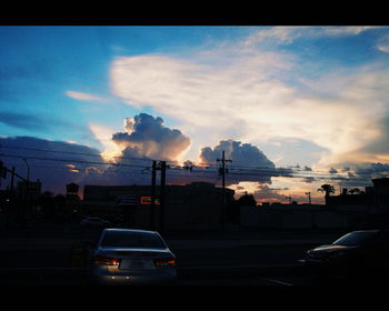 Road against cloudy sky at sunset