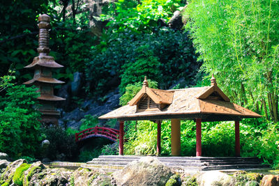 Built structure by trees and building in forest