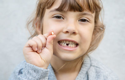 Portrait of smiling girl with broken tooth