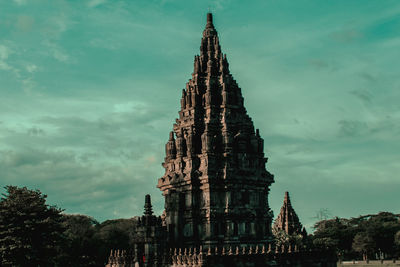 Low angle view of temple building against cloudy sky