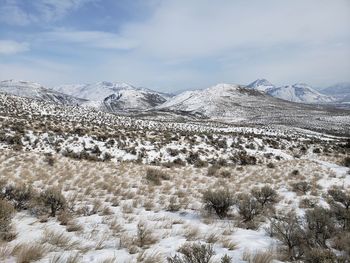 Scenic view of snowcapped mountains against sky