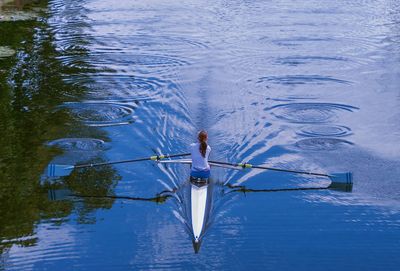 High angle view of woman sailing boat in lake