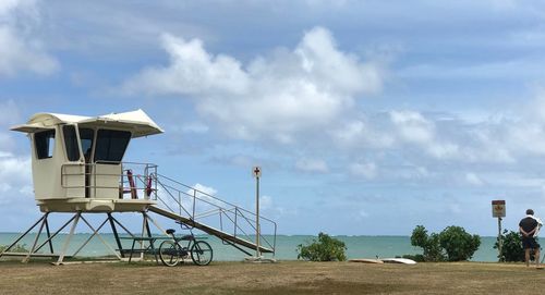 Lifeguard hut on beach against sky