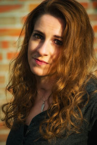 Portrait of woman with wavy brown hair outdoors
