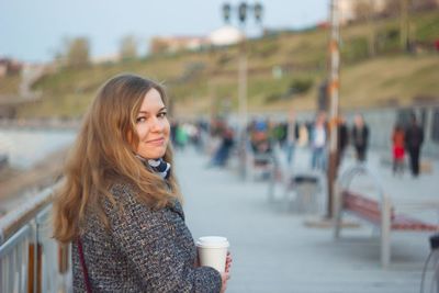 Portrait of young woman standing outdoors