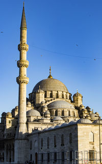 Low angle view of historic building against clear blue sky