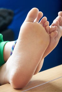 Low section of woman relaxing on table