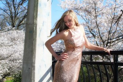 Beautiful young woman against tree