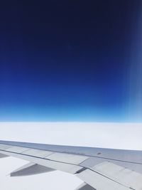 Airplane wing against blue sky