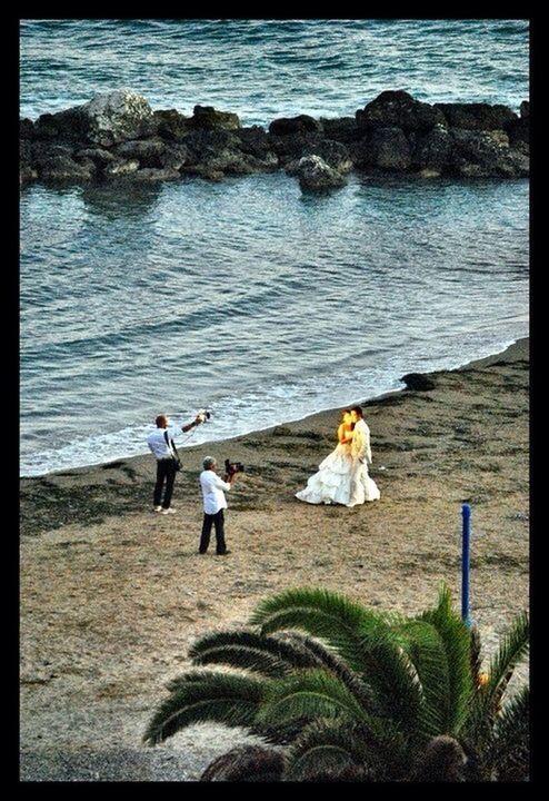 transfer print, water, sea, leisure activity, lifestyles, men, auto post production filter, beach, person, shore, full length, nature, rear view, sunlight, sand, togetherness, tranquility, beauty in nature